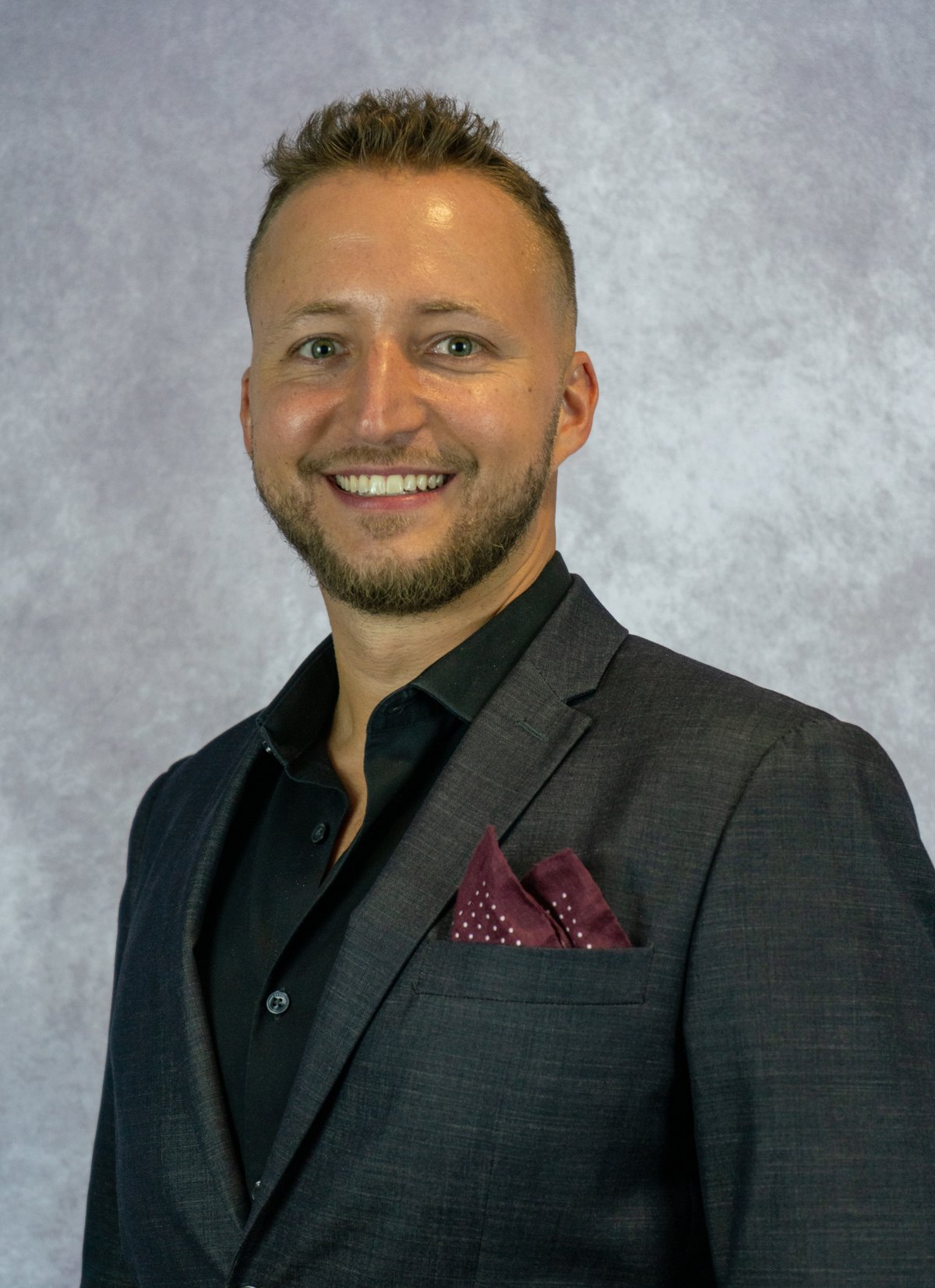 Corporate headshot, navy suit, studio backdrop